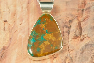 Genuine Crow Springs Turquoise set in Sterling Silver Pendant. Created by Navajo Artist Phillip Sanchez. Signed. The Crow Springs Mine is located near Tonopah, Nevada. Free 18 inch Sterling Silver Chain with purchase.